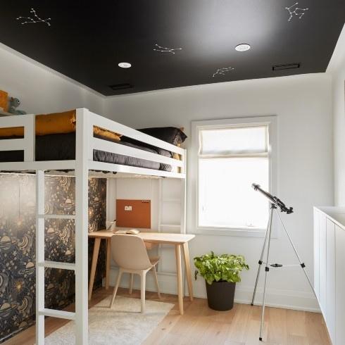 Out of This World Loft bed in a bedroom with white walls and black ceiling