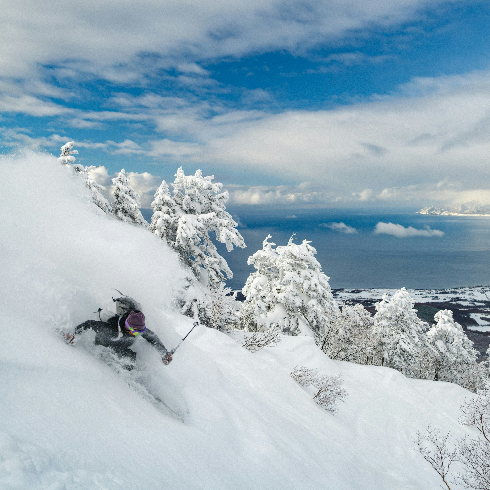 Niseko United, Japan A single skiier speeding down a mountain at Niseko United Ski Resort in Hokkaido, Japan.