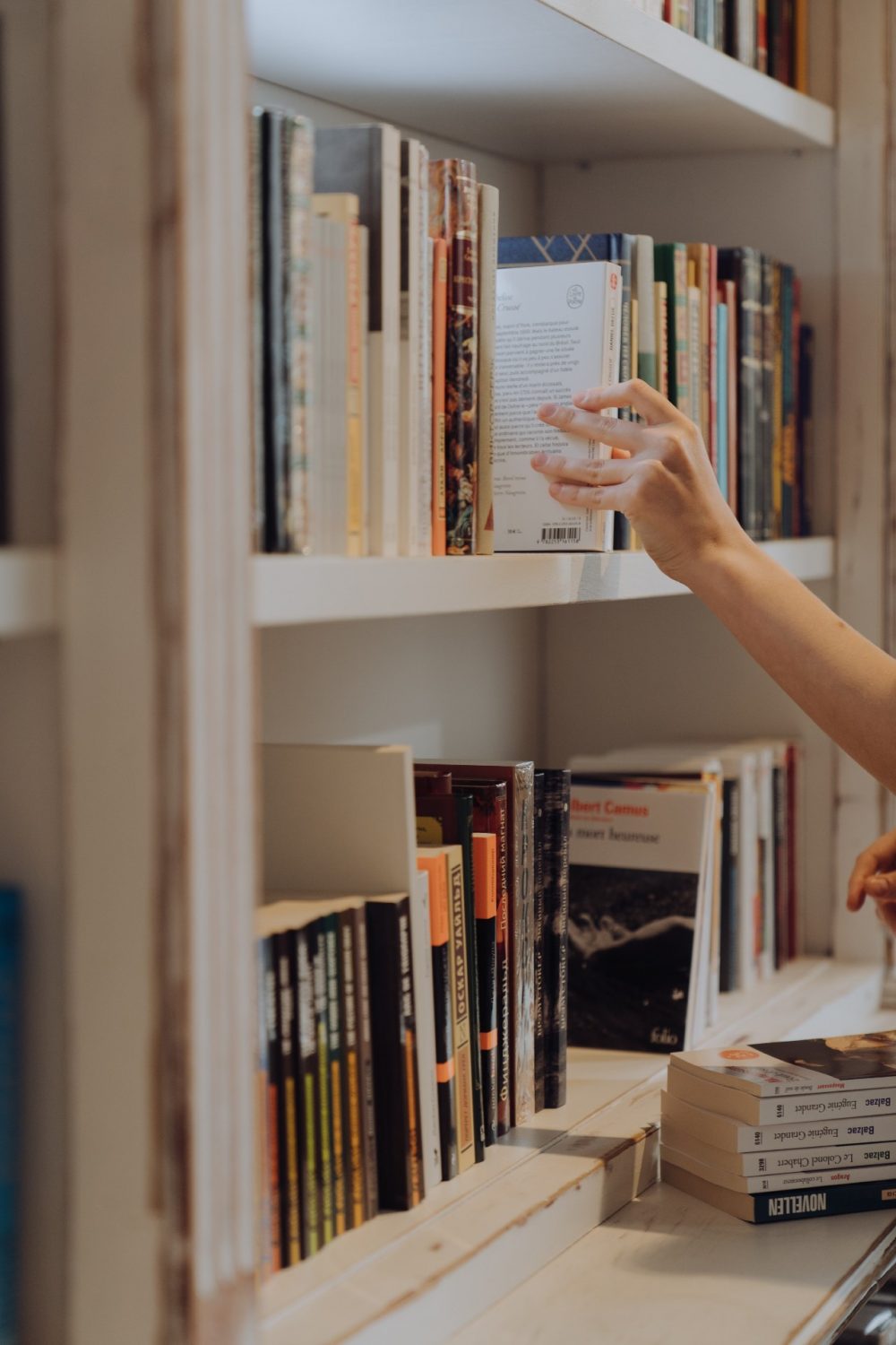 Even More Decluttering Strategies Hand organizing shelves