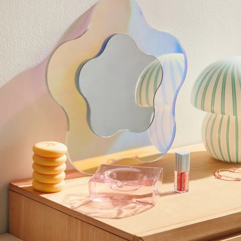 Shaped Mirrors A flower-shaped mirror on a dresser.