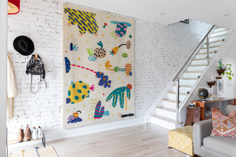 A Lucky Find White brick wall with colourful wall tapestry and staircase