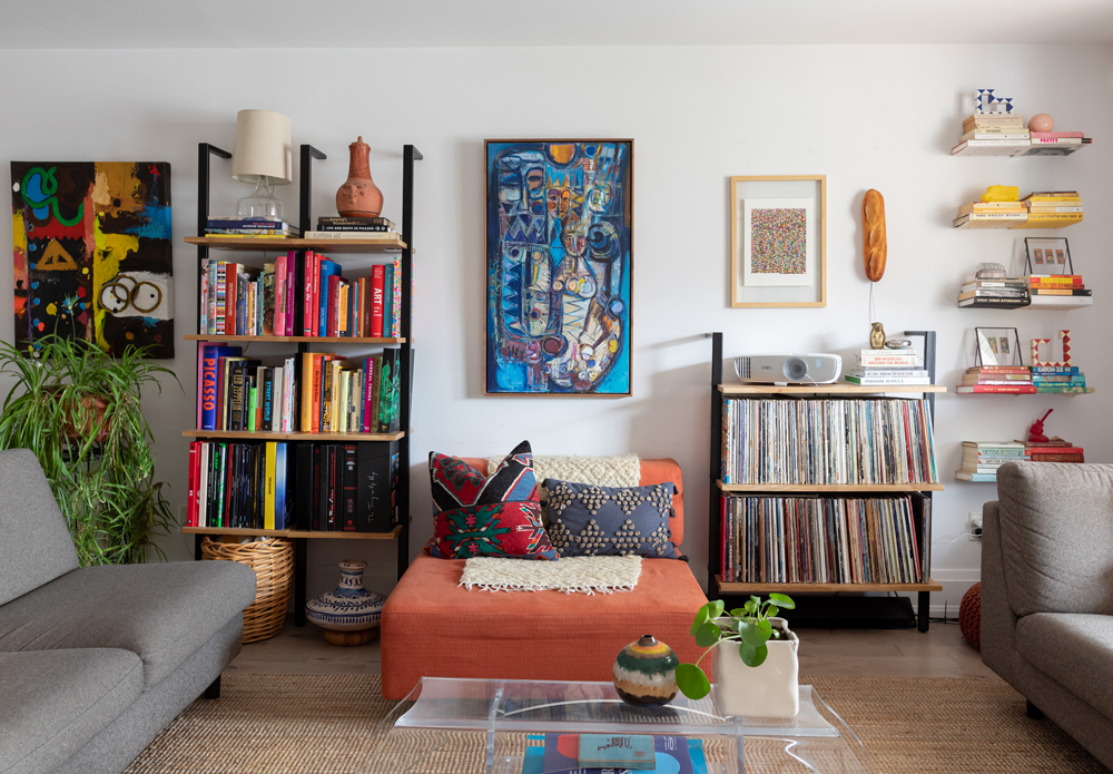 Vibrant by Design White living room with ladder shelving and vintage treasures on the shelves