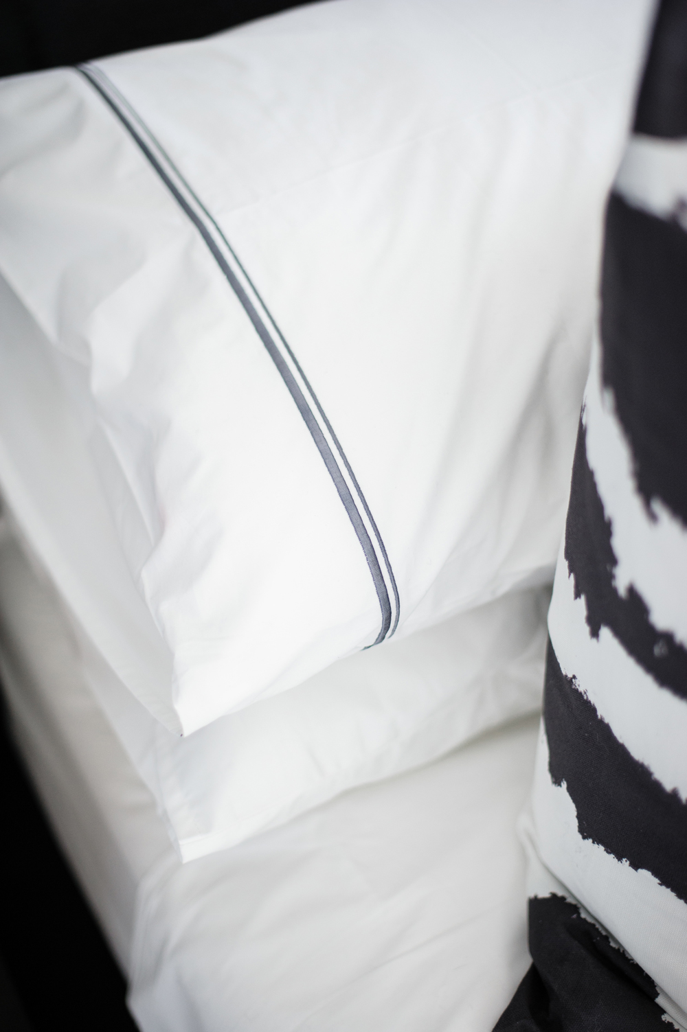 Artful Stacking Stacked pillows on the master bed