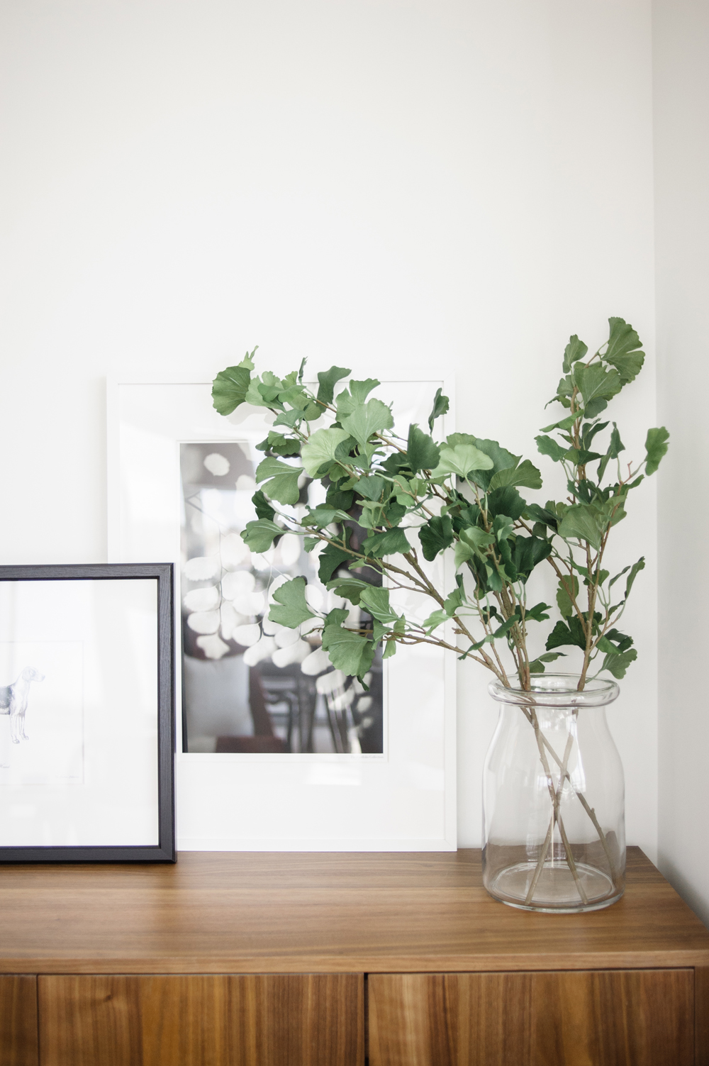 A Hint of Spring Green leaves in a jar on top of a living room sideboard