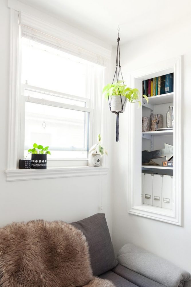 Hang Plants From the Cieling Bright book nook with macrame plant hanger and book shelf