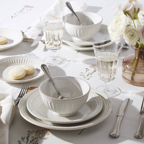 Select a Simple-to-Serve Menu Two table settings, each with white plates and a matching bowl, are on an elegant tablescape.
