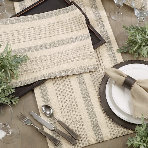 Enhance Year-Round Holiday Decor A rustic striped table runner and matching dinnerware sit on a wood table.