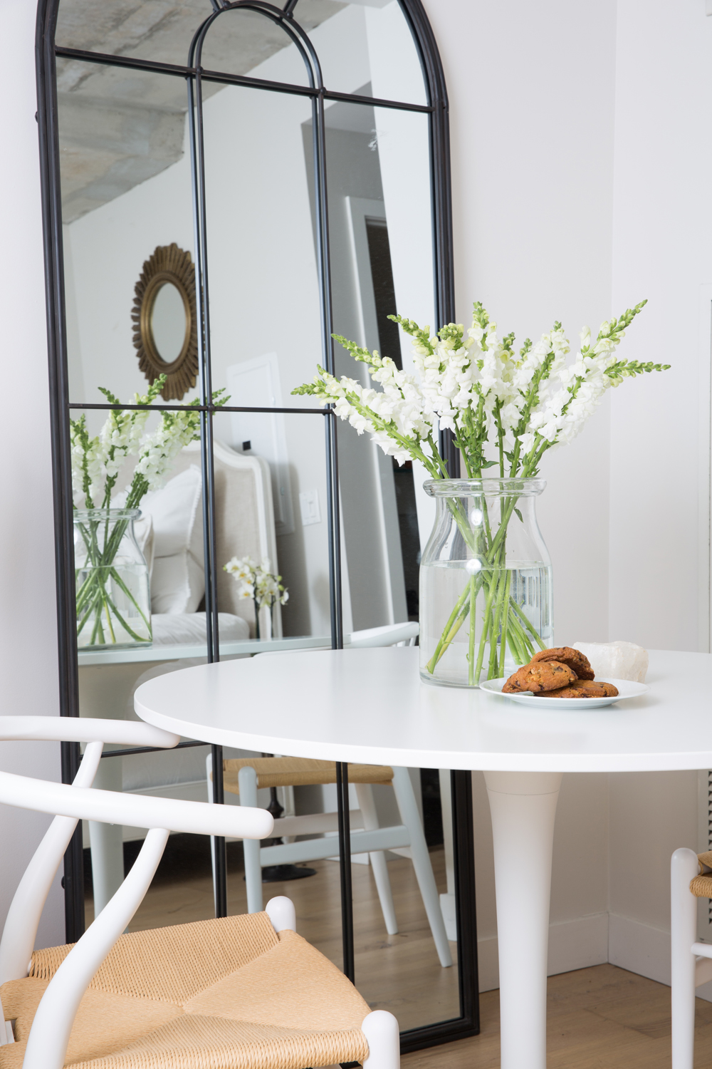 A Bistro-Inspired Dining Nook White dining nook with black bistro mirror