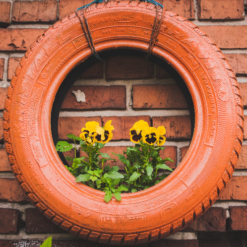 Upcycle Materials for a Vintage Planter A vintage orange tire made into an upcycled planter